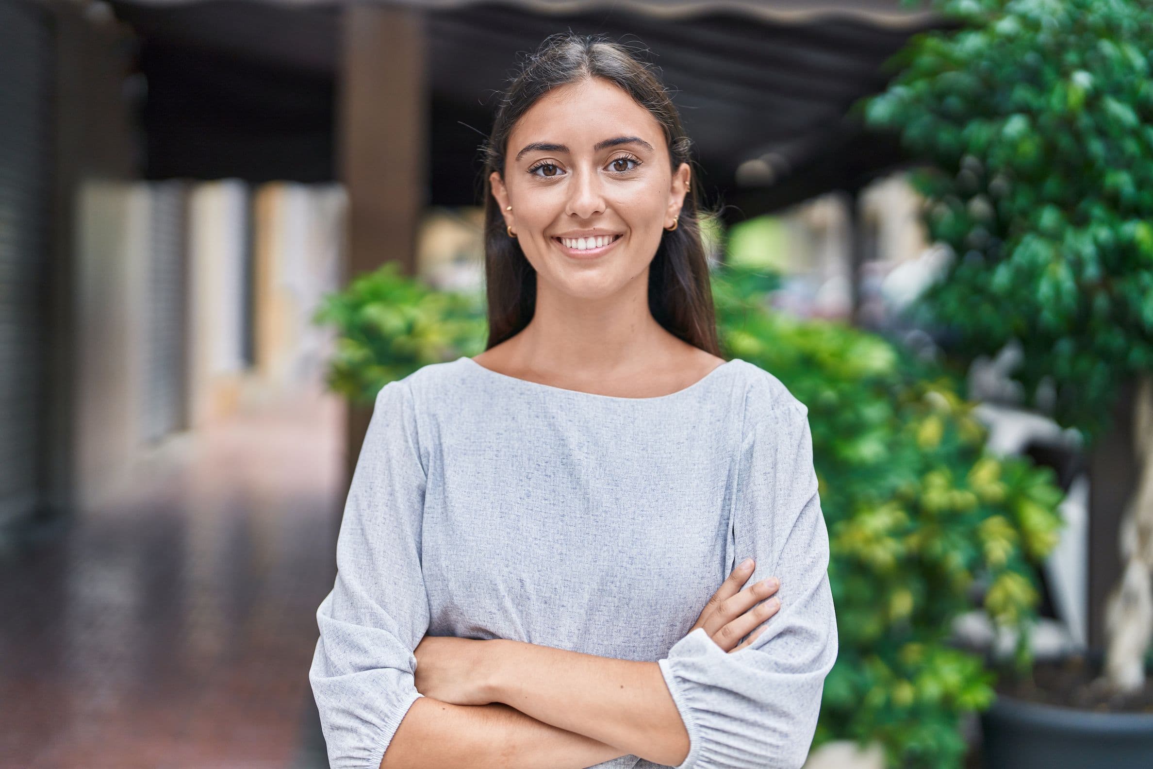 happy woman smilling with arms crossed